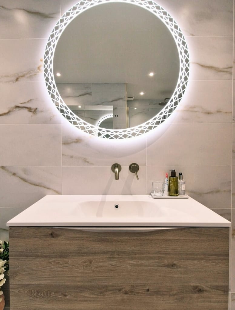 Round Hib Bellus mirror above brush brass wall mounted tap in bearsden