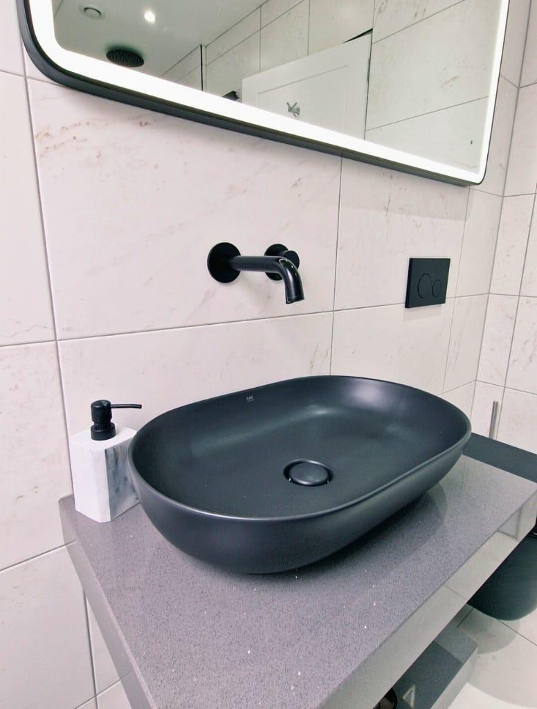 Black sit on bowl and wall mounted tap in Milngavie
