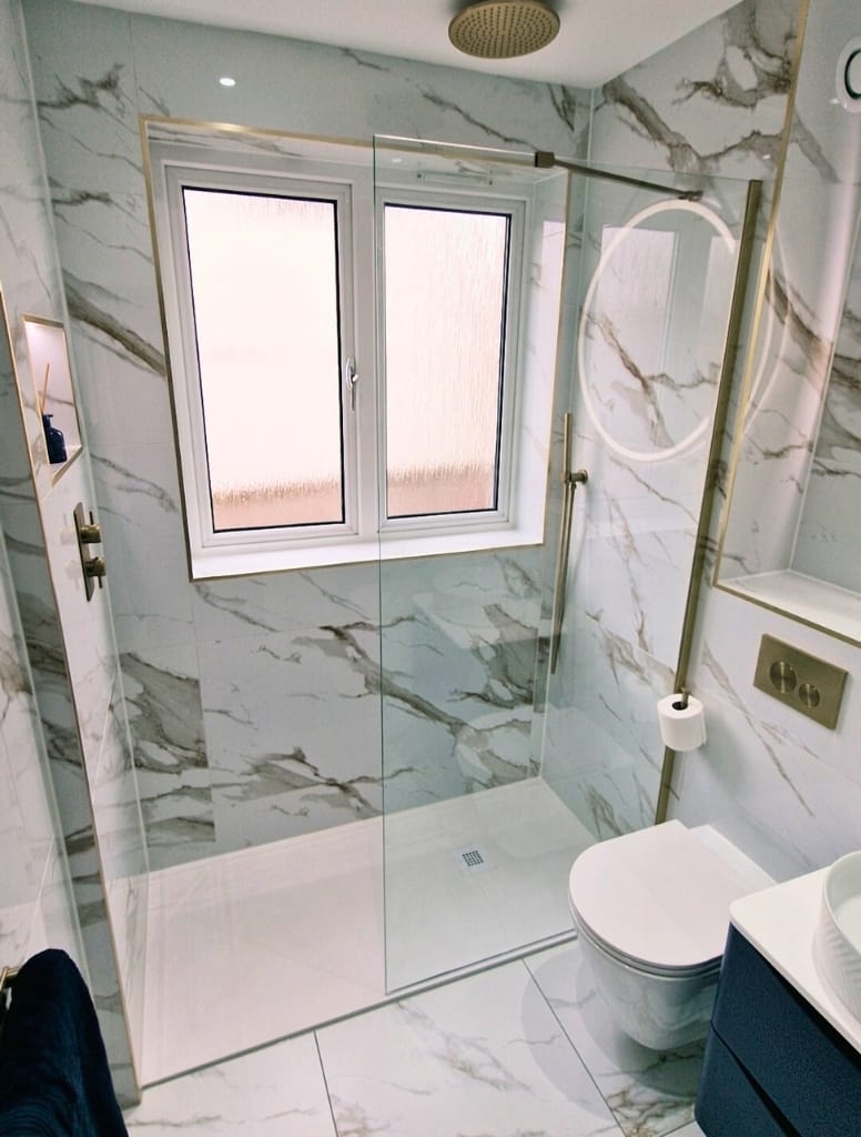 Walk in shower with slate shower tray and marble effect tiles in Milngavie