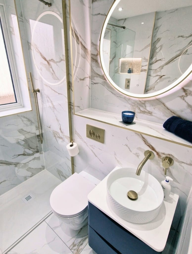 Bathroom with marble effect tiles and brush brass brassware in Milngavie