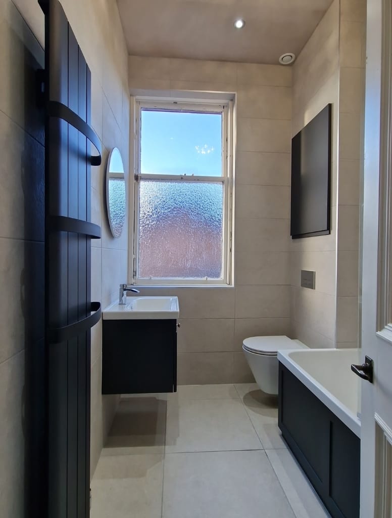 Bathroom with light tiles and anthracite bathroom suite in Clarkston