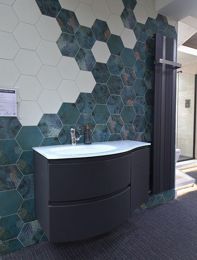 Contemporary bathroom in Hillington, Glasgow, with a floating vanity against a decorative hexagonal tile feature wall, offering a blend of botanical and modern design.